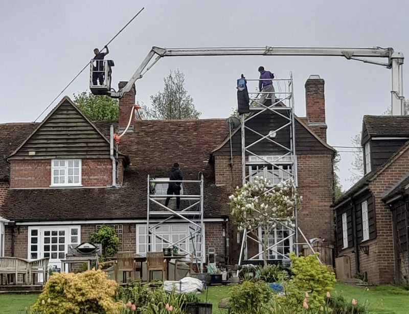 The Moss Cleaners using cherry picker and scaffolding to clean roof safely and professionally in Waterlooville, Hampshire
